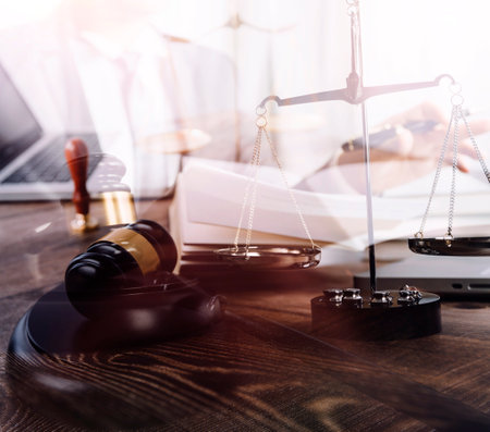 Business and lawyers discussing contract papers with brass scale on desk in office. Law, legal...