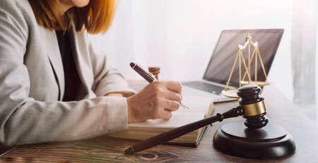 Business and lawyers discussing contract papers with brass scale on desk in office. Law, legal...