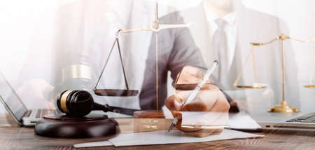 Business and lawyers discussing contract papers with brass scale on desk in office. Law, legal...