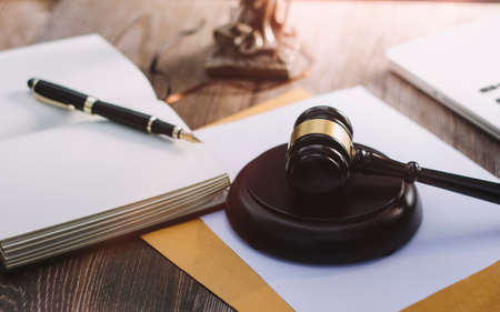 Business and lawyers discussing contract papers with brass scale on desk in office. Law, legal...
