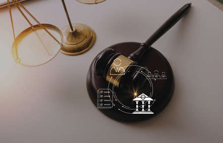 justice and law concept.Male judge in a courtroom on wooden table and Counselor or Male lawyer...