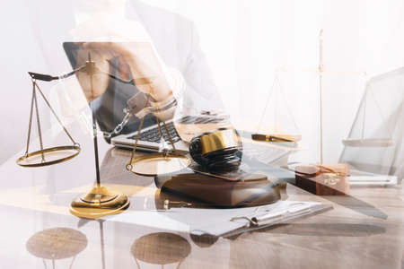 Justice and law concept.Male judge in a courtroom with the gavel, working with, computer and docking...