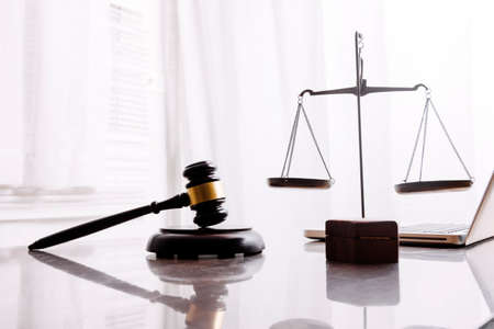 Business and lawyers discussing contract papers with brass scale on desk in office. Law, legal...