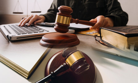 Male lawyer working with contract papers and wooden gavel on tabel in courtroom. justice and law...