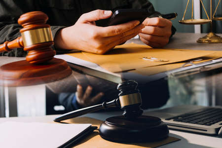 Male lawyer working with contract papers and wooden gavel on tabel in courtroom. justice and law...