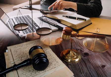 Male lawyer working with contract papers and wooden gavel on tabel in courtroom. justice and law...