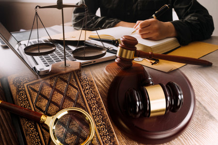 Male lawyer working with contract papers and wooden gavel on tabel in courtroom. justice and law...