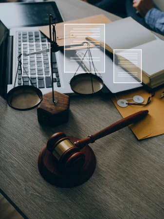 Male lawyer working with contract papers and wooden gavel on tabel in courtroom. justice and law...