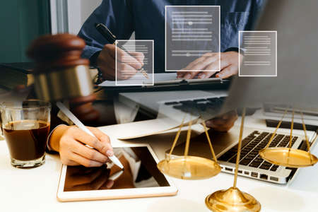 Male lawyer working with contract papers and wooden gavel on tabel in courtroom. justice and law...
