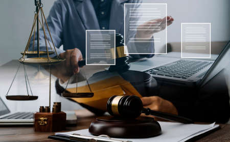 Male lawyer working with contract papers and wooden gavel on tabel in courtroom. justice and law...