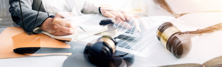 Justice and law concept. Gavel on sounding block in hand's Male judge at a courtroom, working with...
