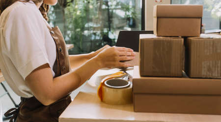Portrait of Starting small businesses SME owners, two Asian woman check online orders Selling...