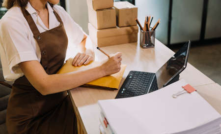 Portrait of Starting small businesses SME owners, two Asian woman check online orders Selling...