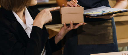 Portrait of Starting small businesses SME owners, two Asian woman check online orders Selling...