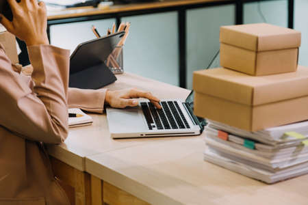 Portrait of Starting small businesses SME owners, two Asian woman check online orders Selling...