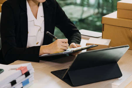 Portrait of Starting small businesses SME owners, two Asian woman check online orders Selling...