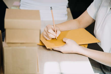 Portrait of Starting small businesses SME owners, two Asian woman check online orders Selling...