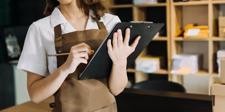 Portrait of Starting small businesses SME owners, two Asian woman check online orders Selling...