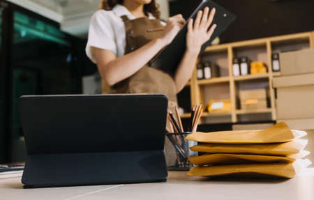 Portrait of Starting small businesses SME owners, two Asian woman check online orders Selling...