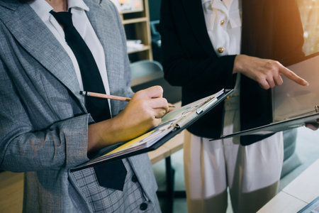 Woman accountant use calculator and computer with holding pen on
