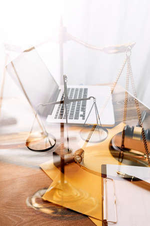 Business and lawyers discussing contract papers with brass scale on desk in office. Law, legal services, advice, justice and law concept picture with film grain effectの写真素材