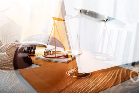 Business and lawyers discussing contract papers with brass scale on desk in office. Law, legal services, advice, justice and law concept picture with film grain effectの写真素材