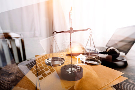 Business and lawyers discussing contract papers with brass scale on desk in office. Law, legal services, advice, justice and law concept picture with film grain effectの写真素材