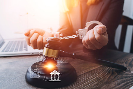 Business and lawyers discussing contract papers with brass scale on desk in office. Law, legal services, advice, justice and law concept picture with film grain effectの写真素材