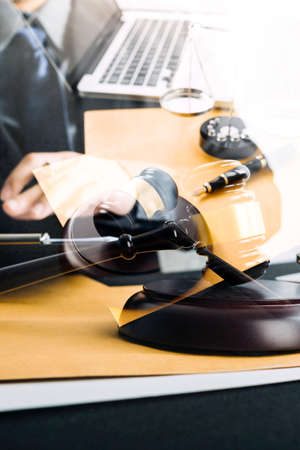 Business and lawyers discussing contract papers with brass scale on desk in office. Law, legal services, advice, justice and law concept picture with film grain effectの写真素材