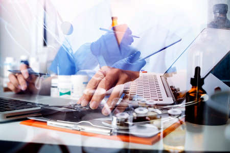 Double exposure of technology healthcare And Medicine concept. Two doctors using digital tablet and...