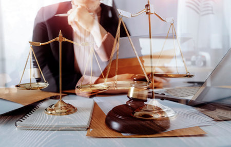 Business and lawyers discussing contract papers with brass scale on desk in office. Law, legal...