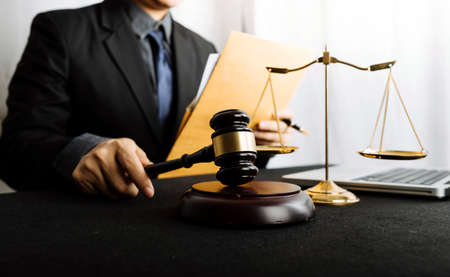 Business and lawyers discussing contract papers with brass scale on desk in office. Law, legal...