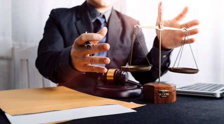 Business and lawyers discussing contract papers with brass scale on desk in office. Law, legal...