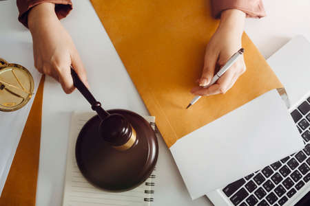 Business and lawyers discussing contract papers with brass scale on desk in office. Law, legal...