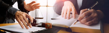 justice and law concept.Male judge in a courtroom on wooden table and Counselor or Male lawyer...