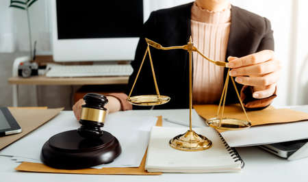 Justice and law concept.Male judge in a courtroom with the gavel, working with, computer and docking...