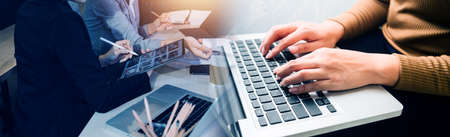 Business team finance or bookkeeper working with a calculator to calculate business data summary...