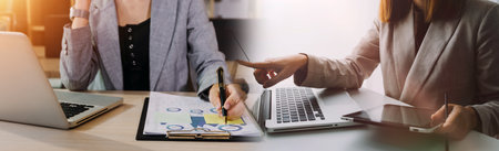 Business team finance or bookkeeper working with a calculator to calculate business data summary...