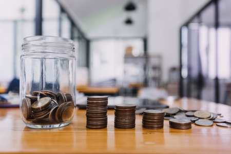 businessman hand putting coin in piggy bank. Saving money concept, business finance and investment.