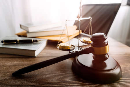 justice and law concept.Male judge in a courtroom on wooden table and Counselor or Male lawyer...