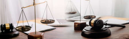 justice and law concept.Male judge in a courtroom on wooden table and Counselor or Male lawyer...