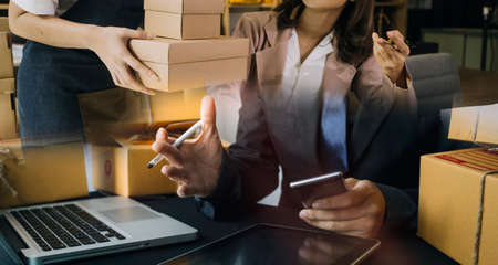 Portrait of Starting small businesses SME owners, two Asian woman check online orders Selling...