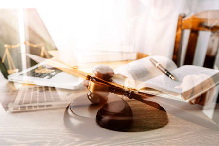 Justice and law concept.Male judge in a courtroom with the gavel, working with, computer and docking...