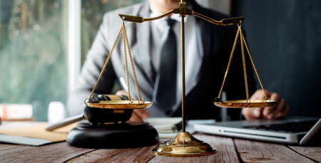 Justice and law concept.Male judge in a courtroom with the gavel, working with, computer and docking...