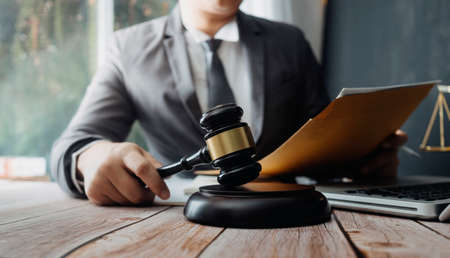 Business and lawyers discussing contract papers with brass scale on desk in office. Law, legal...