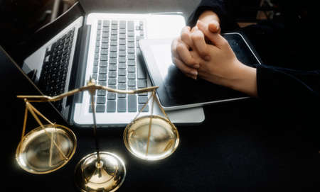 Justice and law concept.Male judge in a courtroom with the gavel, working with, computer and docking...