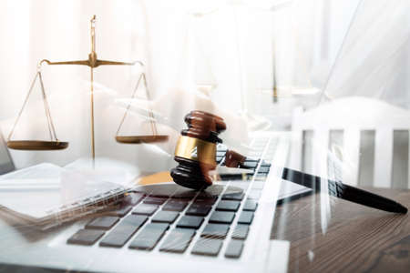 Justice and law concept.Male judge in a courtroom with the gavel, working with, computer and docking...