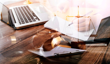 Business and lawyers discussing contract papers with brass scale on desk in office. Law, legal...