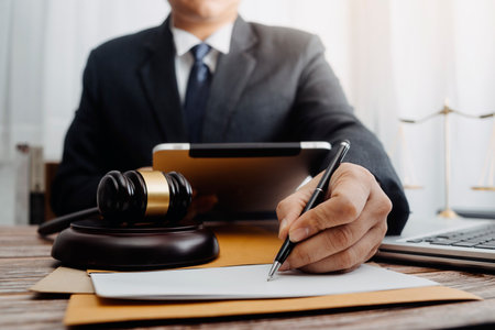 Business and lawyers discussing contract papers with brass scale on desk in office. Law, legal...
