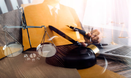 Justice and law concept.Male judge in a courtroom with the gavel, working with, computer and docking...